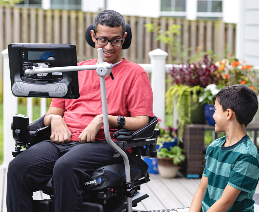 Allistair, a man with ALS/MND using a Tobii Dynavox speech generating device mounted to his wheelchair with a ConnectIT Wheelchair Mount